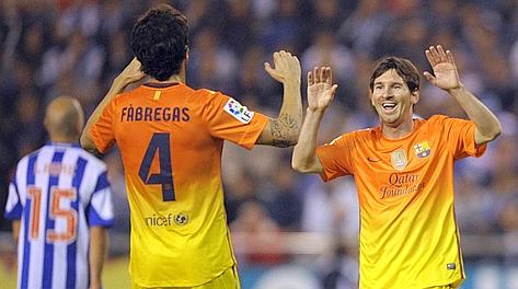 Lionel Messi festeggia con Cesc Fabregas: tre gol per Leo, tre assist per il catalano. Afp