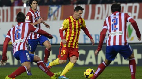 Leo Messi circondato da difensori dell'Atletico. Afp