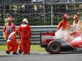 Alonso osserva sconsolato la sua vettura ferma a bordo pista. Reuters