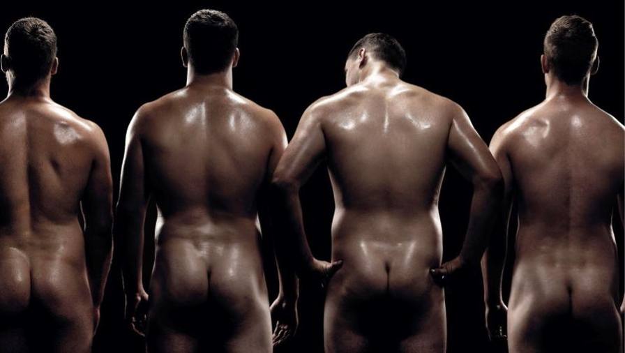 Team rugby men naked in shower.