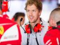 Sebastian Vettel pronto a calarsi nell'abitacolo della Ferrari. Lapresse